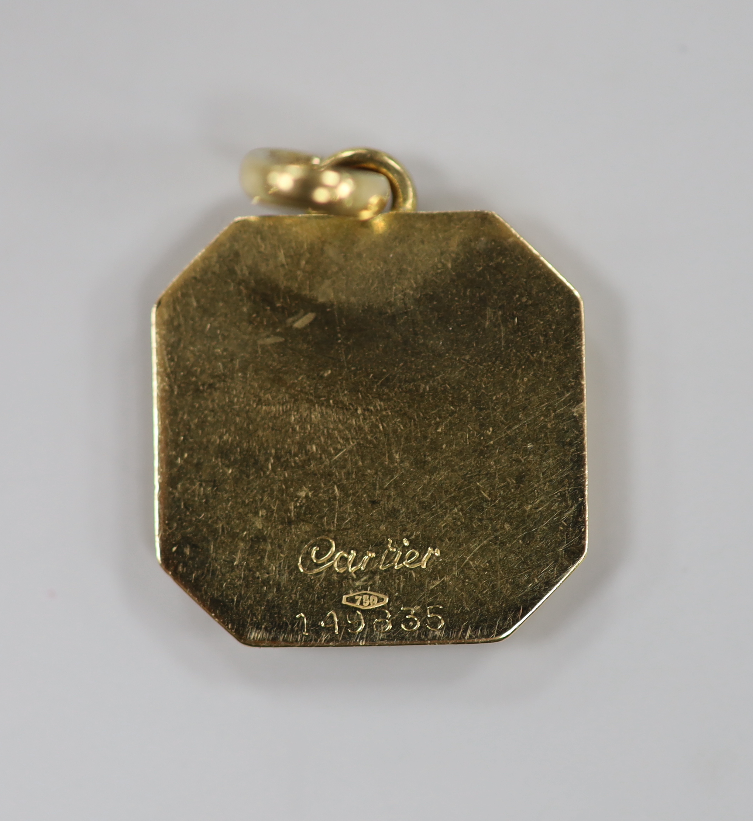 A small Cartier 750 octagonal pendant, engraved with the letter S, numbered 149835, 15mm, 4 grams.